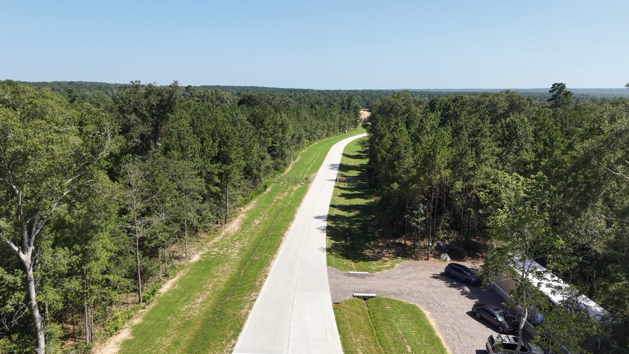Aerial view of a road winding between the trees at Whitetail Ranch